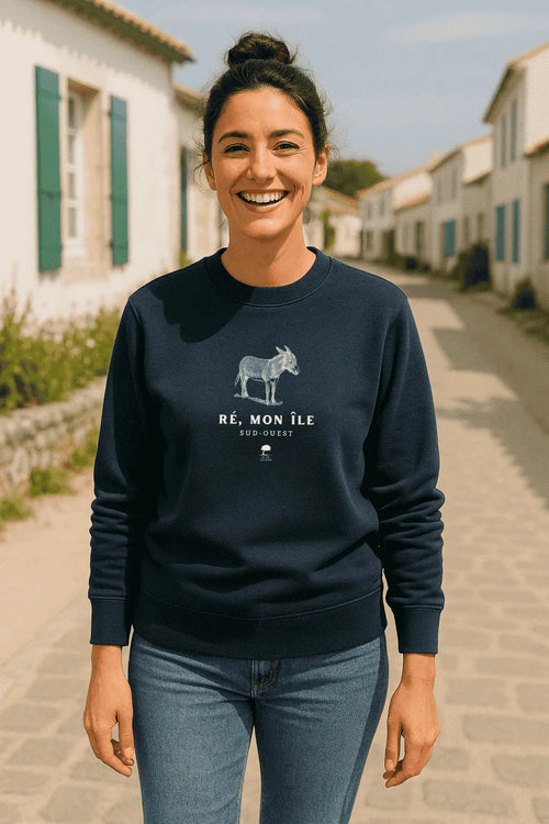 Femme portant un sweat éco-responsable Au Fil des Pins dans une rue de l’Île de Ré, style décontracté et authentique du Sud-Ouest.